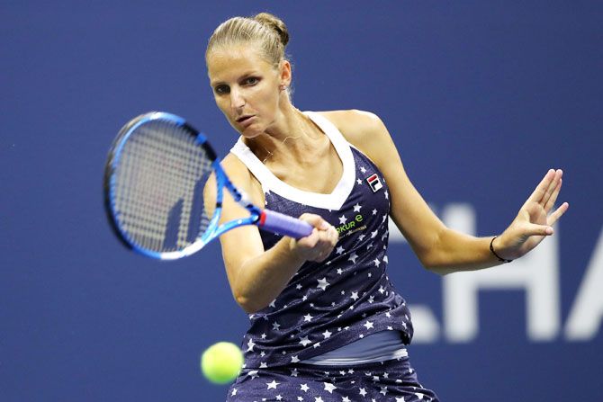 Czech Republic's Karolina Pliskova returns the ball during her women's singles quarter-final against USA's Serena Williams