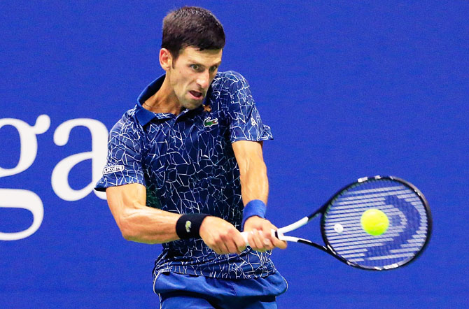 Novak Djokovic plays a return against John Millman