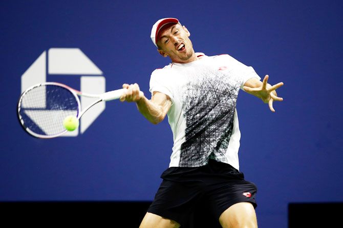 John Millman plays a return during his US Open quarter-final against Novak Djokovi