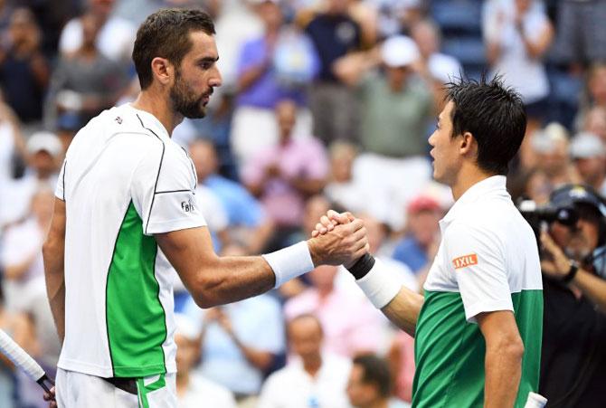 Marin Cilic (left) congratulates and Kei Nishikori after the match 