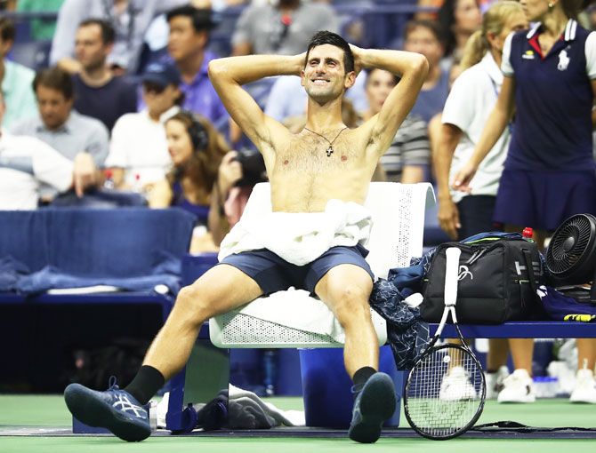 Novak Djokovic relaxes during the unscheduled break taken by John Millman