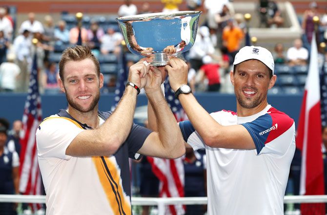Jack Sock and Mike Bryan of The United States celebrate after beating Lukasz Kubot of Poland and Marcelo Melo of Brazil to win the US Open men's doubles final at the USTA Billie Jean King National Tennis Center on in New York City on Friday
