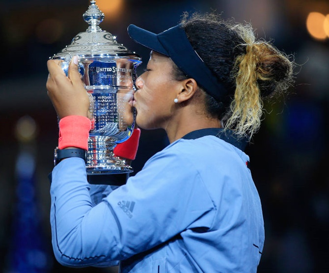 Naomi Osaka of Japan kisses the US Open championship trophy