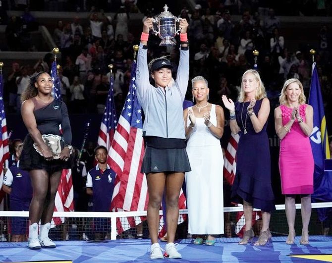 Japan's Naomi Osaka hoists the US Open trophy after beating Serena Williams of the United States in the US Open women’s singles final