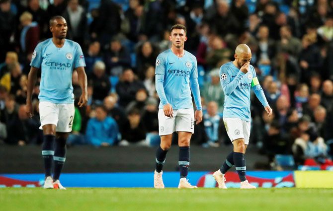 Manchester City's Fernandinho, Aymeric Laporte and David Silva look dejected after Lyon's second goal