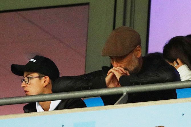 Manchester City manager Pep Guardiola looks dejected in the stands during the match against Olympic Lyon at Etihad Stadium on Wednesday