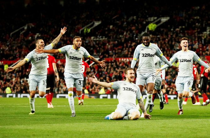 Derby County's Jack Marriott celebrates scoring their second goal with teammates during their Third Round League Cup match at Old Trafford, in Manchester on Tuesday
