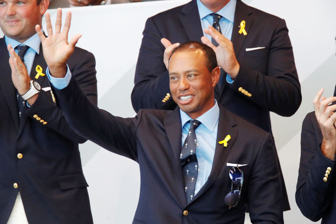 USA's Tiger Woods waves during the opening ceremony