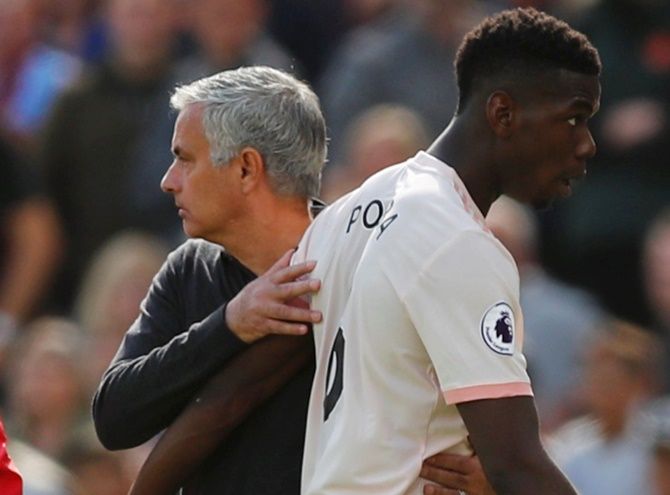 Manchester United's Paul Pogba with manager Jose Mourinho after being substituted off