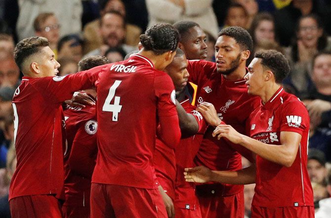 Liverpool players celebrate with Daniel Sturridge on scoring the equaliser against Chelea at Stamford Bridge in London on Saturday