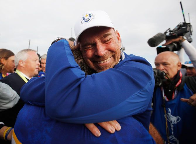 Team Europe's Francesco Molinari celebrates with captain Thomas Bjorn after winning the Ryder Cup at Le Golf National Guyancourt, France