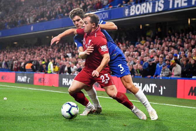 Chelsea's Marcos Alonso tackles Liverpool's Xherdan Shaqiri