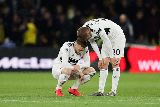Fulham's Calum Chambers and Maxime Le Marchand wear a dejected look after their team were relegated after a 4-1 loss to Watford FC at Vicarage Road in Watford
