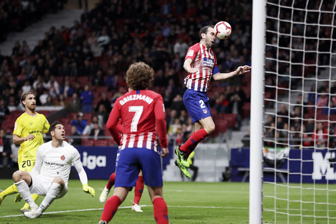 Atletico Madrid's Diego Godin scores his team's first goal against Girona FC at Wanda Metropolitano in Madrid on Tuesday