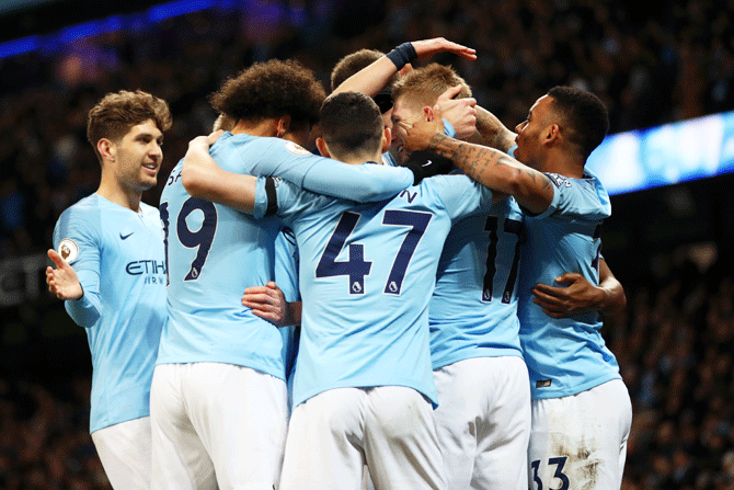 Manchester City's Kevin De Bruyne celebrates with his team mates after scoring his team's first goal against Cardiff City at Etihad Stadium in Manchester on Wednesday