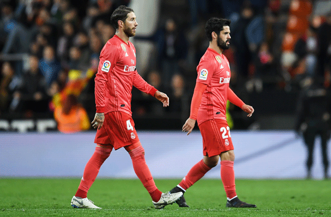 A dejected Sergio Ramos (left) and Isco leave the field following Real Madrid's defeat to Valencia