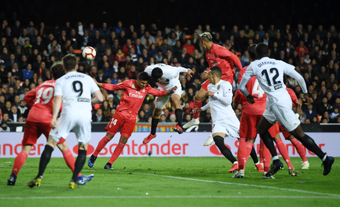 Valencia's (centre) Ezequiel Garay scores his side's second goal against Real Madrid CF at Estadio Mestalla in Valencia on Wednesday