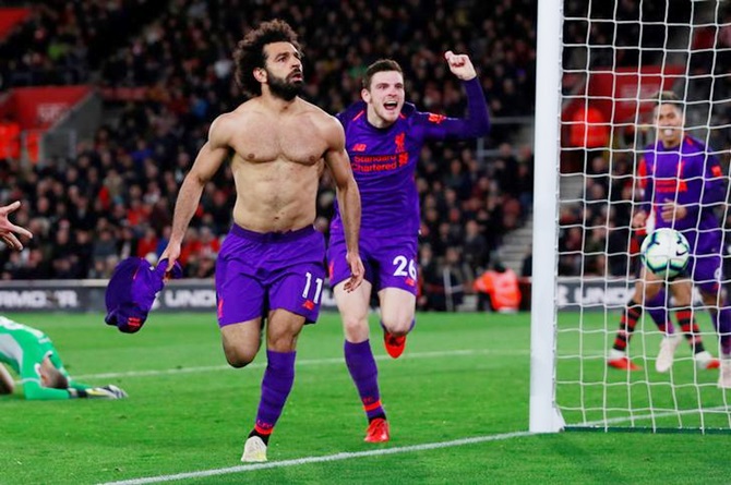 Liverpool's Mohamed Salah celebrates with teammate Andrew Robertson after scoring the second goal against Southampton during their English Premier League match, at St Mary's Stadium in Southampton on Friday, April 5.