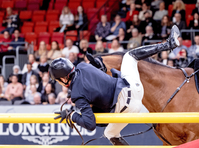 Beat Maendli of Switzerland falls off Dsarie during the FEI World Cup Final 1 Show Jumping event at Gothenburg Horse Show in Scandinavium arena, Sweden on Wednesday, April 4, 2019