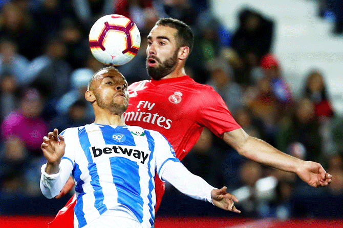 Real Madrid's Dani Carvajal and Leganes' Martin Braithwaite got for an aerial ball