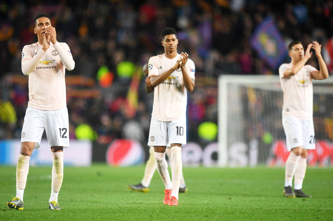 Manchester United's Chris Smalling and Marcus Rashford acknowledge the fans after their UEFA Champions League quarter-final second leg match at Camp Nou in Barcelona, Spain, on Tuesday