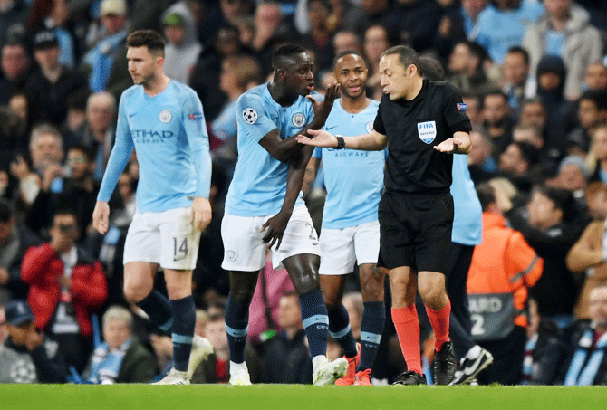Manchester City's Benjamin Mendy speaks confronts referee Cuneyt Cakir