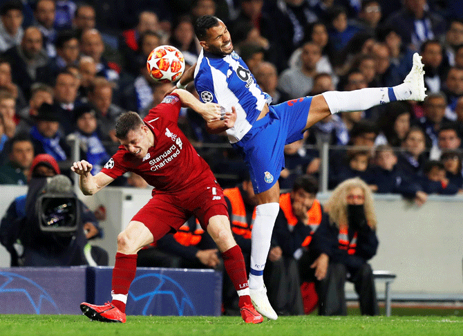 Liverpool's James Milner and FC Porto's Fernando vie for possession