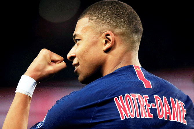 Paris St Germain's Kylian Mbappe, with 'Notre-Dame' on the back of his shir, celebrates scoring their third goal and completing his hat-trick against AS Monaco during their Ligue 1 match at Parc des Princes stadium in Paris on Sunday, April 21