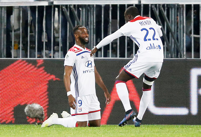Lyon's Moussa Dembele celebrates with Ferland Mendy after scoring their third goal against Bordeaux at Matmut Atlantique, Bordeaux, France, on Friday