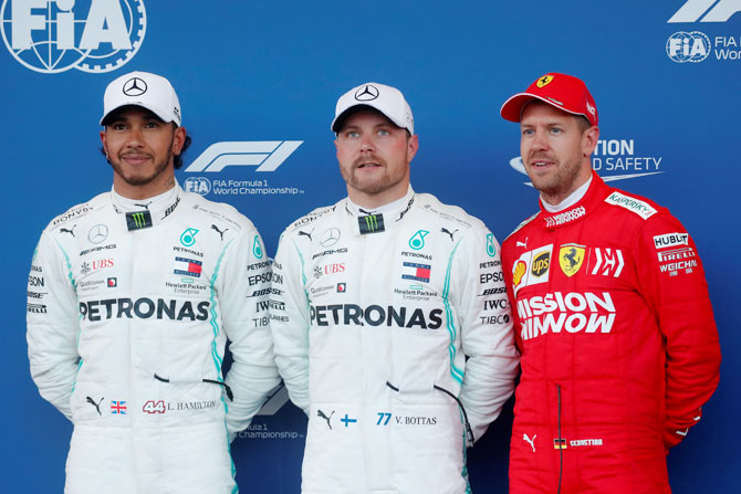 Mercedes' Valtteri Bottas celebrates pole position with second placed Mercedes' Lewis Hamilton and third placed Ferrari's Sebastian Vettel after qualifying for the F1 Azerbaijan Grand Prix at Baku City Circuit, in Baku, Azerbaijan on Saturday