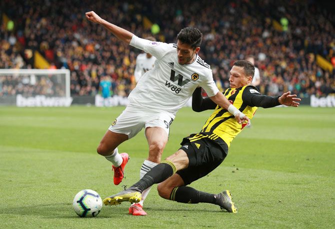 Wolverhampton Wanderers' Raul Jimenez in action with Watford's Jose Holebas during their match at Vicarage Road, Watford