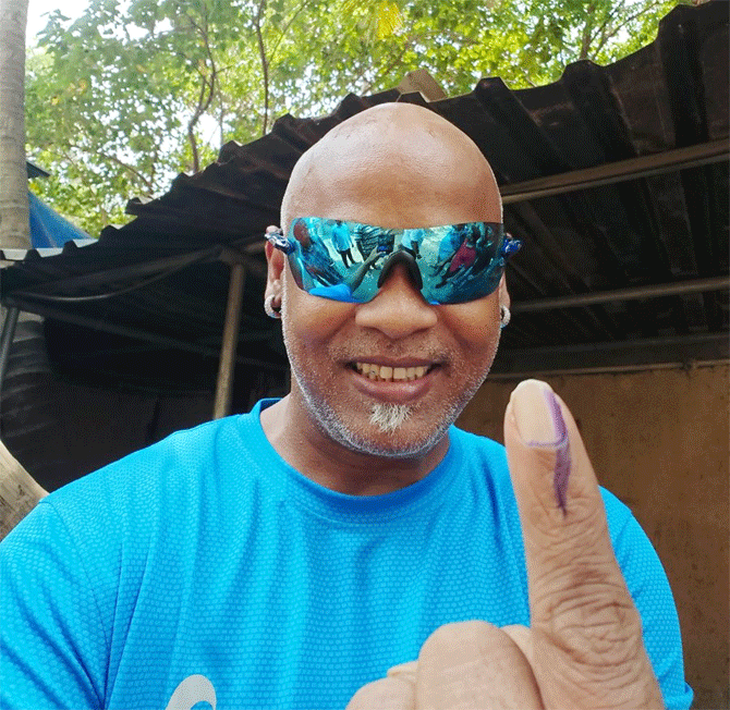 Former India player Vinod Kambli shows off his inked finger