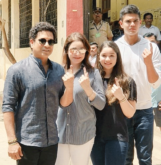 Former India captain Sachin Tendulkar with wife Anjali and children Sara and Arjun outside a polling station after voting