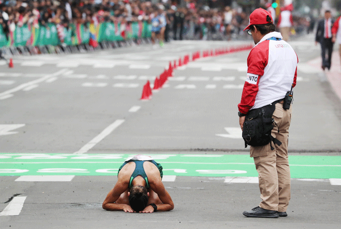 Brazil's Andreia Aparecida Hessel reacts after crossing the finish line after the women's marathon at Kennedy Park on July 27