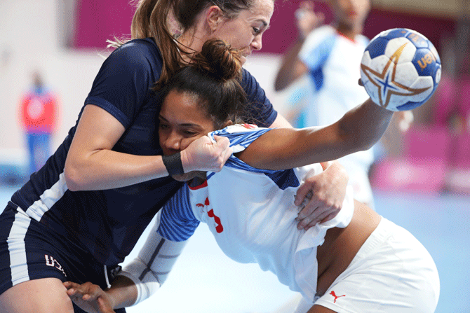 Cuba's Schakira Robert and USA's Zoe Lombard vie for possession during their women's handball bronze medal match at Villa Deportiva Nacional