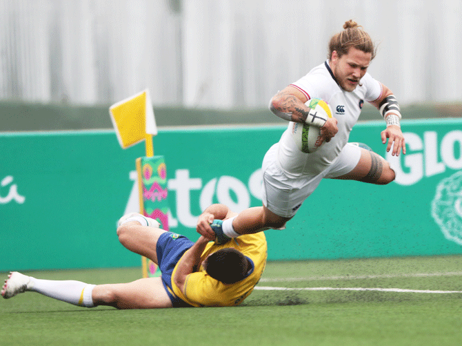 USA's Harley Wheeler is tackled by Brazil's Stefano Giantorno during the rugby sevens men's bronze medal match at Campo de Rugby on July 28