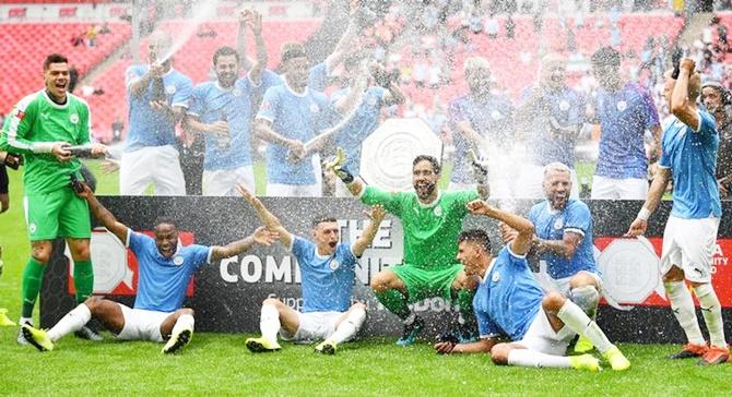 Manchester City players celebrate with the Community Shield