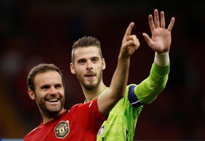 Manchester United's David De Gea and Juan Mata celebrate after victory over A C Milan in the International Champions Cup match
