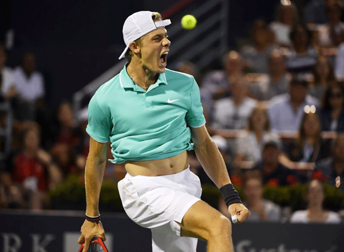 Canada's Denis Shapovalov reacts after defeating France's Pierre-Hughes Herbert during the Rogers Cup tennis tournament at Stade IGA in Montreal, Canada, on Monday