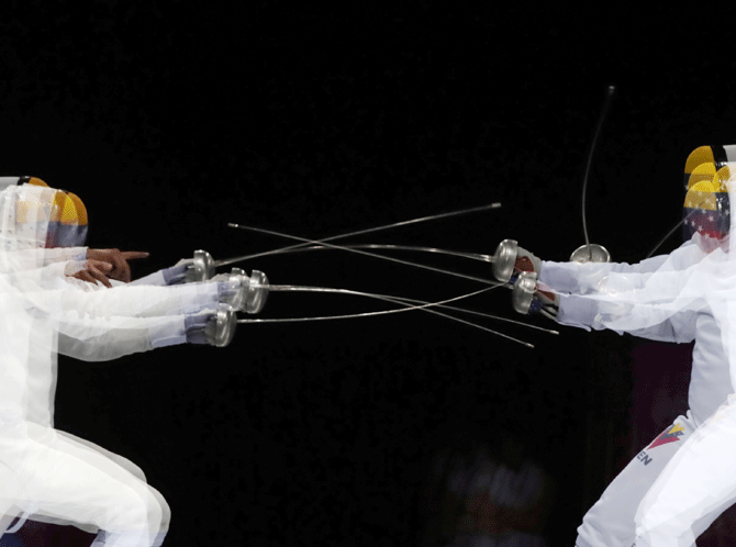 Venezuela's Ruben Limardo and compatriot Jesus Limardo in action during the Men's Epee individual gold medal fencing bout at Lima Conventions Center