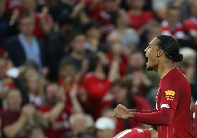 Virgil van Dijk celebrates scoring Liverpool's third goal.