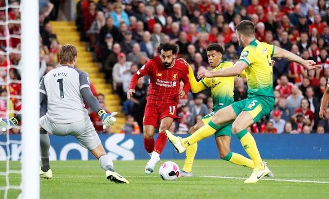Mohamed Salah breaks through Norwich City's defence to score Liverpool's second goal in the Premier League opener at Anfield on Friday.