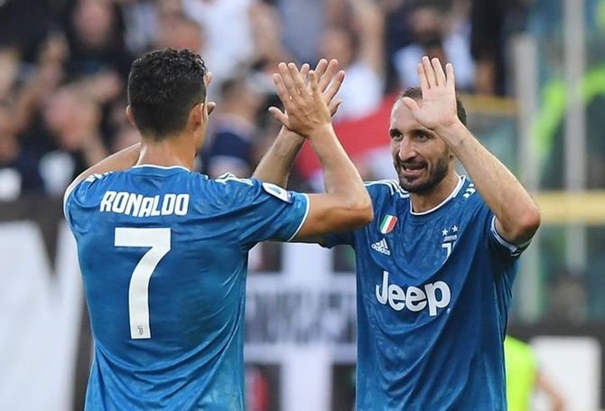 Giorgio Chiellini celebrates with Cristiano Ronaldo after scoring for Juventus in Saturday's Serie A match against Parma.