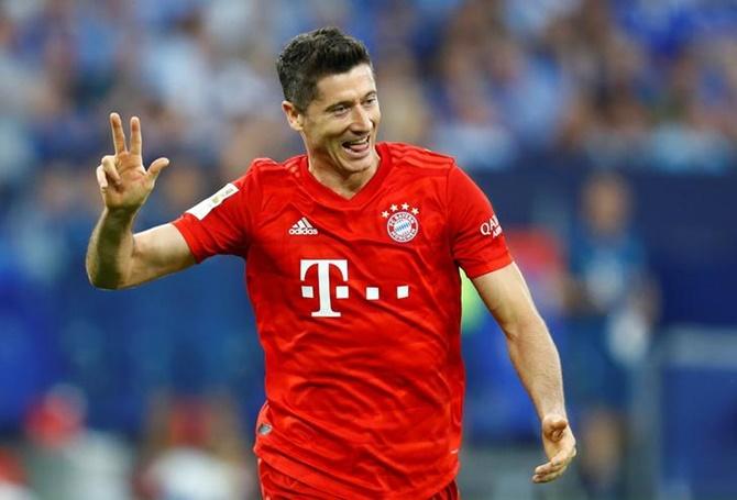  Robert Lewandowski celebrates scoring Bayern Munich's third goal and completing his hat-trick in Saturday's Bundesliga match against Schalke 04.