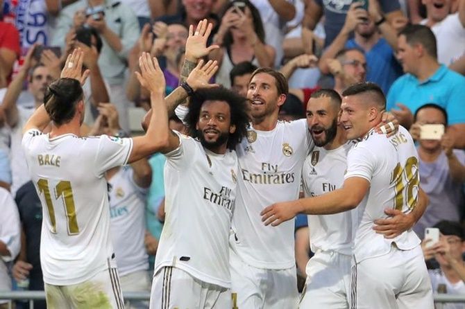 Karim Benzema celebrates with teammates after putting Real Madrid ahead in Saturday's La Liga match against Real Valladolid.