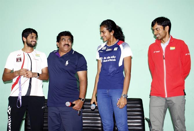PV Sindhu with her coach Pullela Gopichand, right, and B Sai Praneeth, left