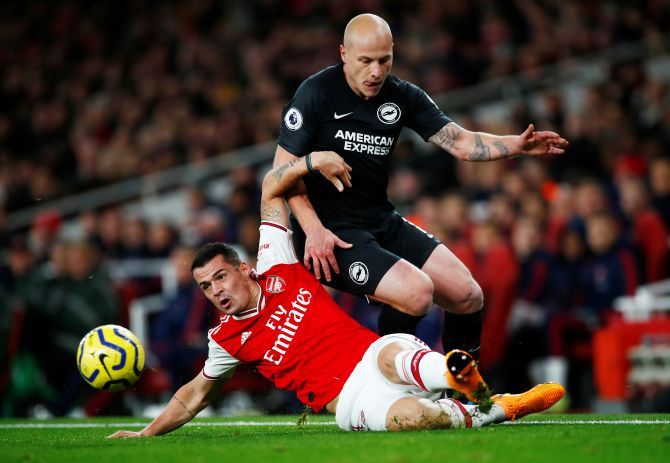 Arsenal's Granit Xhaka challenges Brighton & Hove Albion's Aaron Mooy