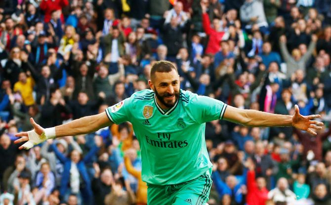 Real Madrid's Karim Benzema celebrates scoring their second goal against Espanyol during their La Liga match at the Santiago Bernabeu in Madrid on Saturday