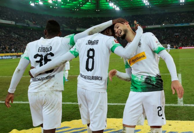 Borussia Moenchengladbach's Ramy Bensebaini celebrates with teammates after scoring their second goal against Bayern Munich at Borussia-Park in Moenchengladbach, Germany, on Saturday 