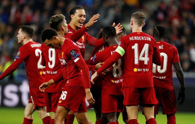 Liverpool's Naby Keita celebrates with Virgil van Dijk and teammates after scoring their first goal against FC Salzburg during their Champions League Group E match at Red Bull Arena Salzburg, Salzburg, Austria